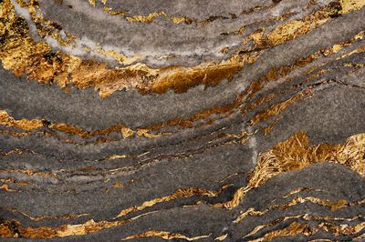 Gray marble rock gold textured.