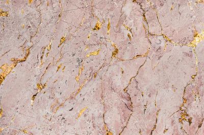 Pink marble rock textured background.