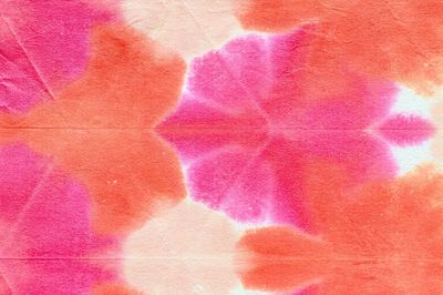 Orange pink shibori patterned background.