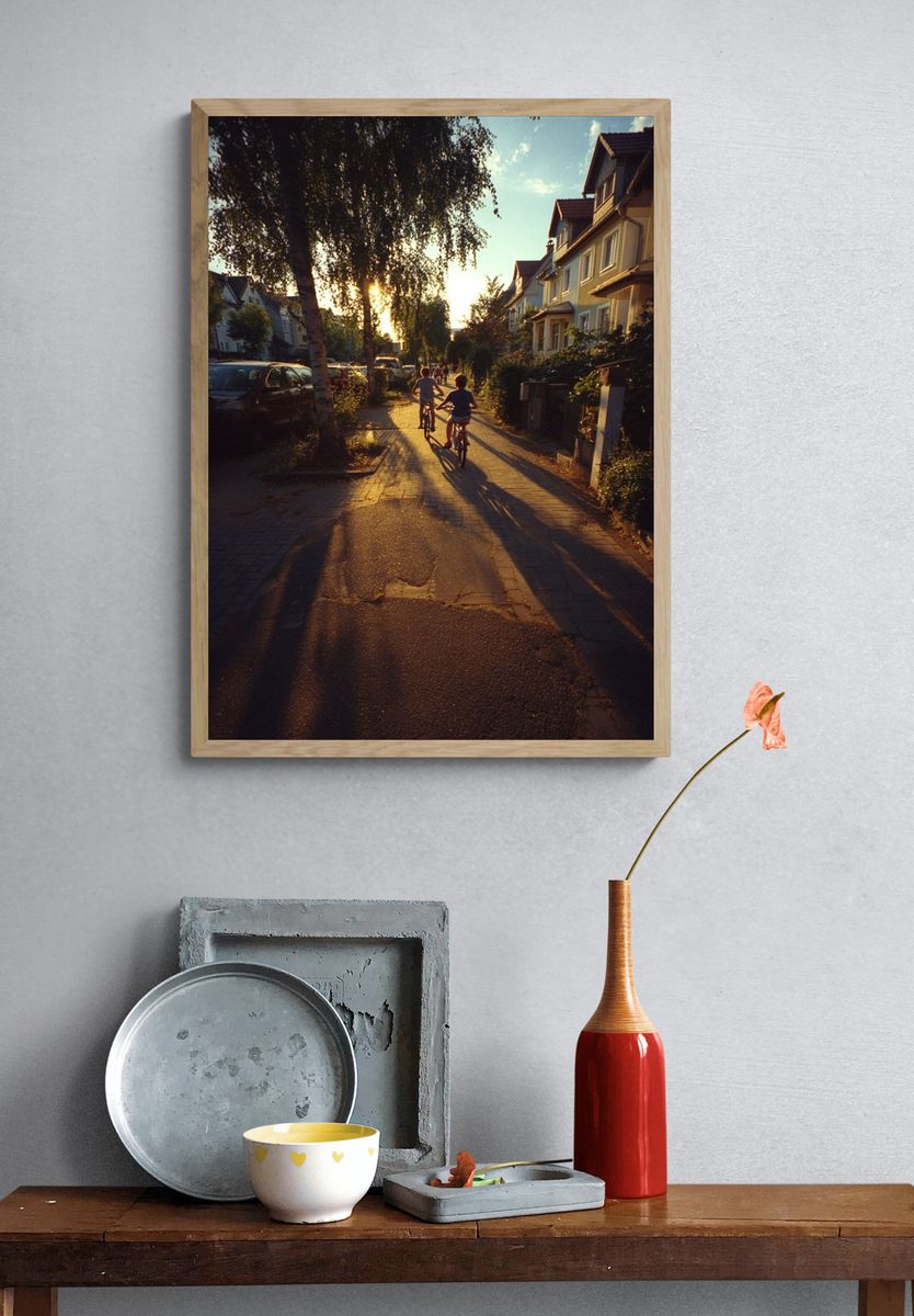 Children Riding Bikes at Sunset Poster. — room view 3