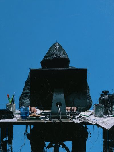 Hooded Figure at Desk — Contemporary Print. poster