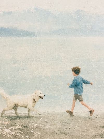Boy and Dog by the Sea Print. poster