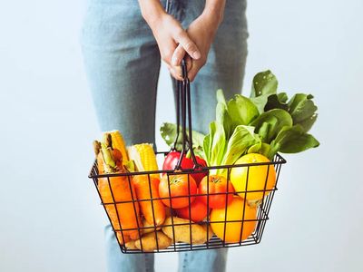 Shopping basket full fruits vegetables.