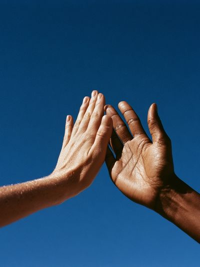 Hands Against Blue Sky Photography Poster.
