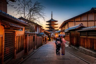 Women exploring japanese village yukata. poster