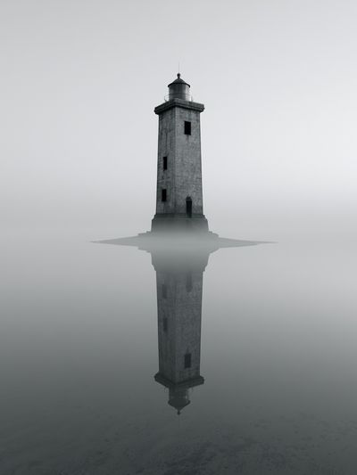 Misty Lighthouse Reflection Print.