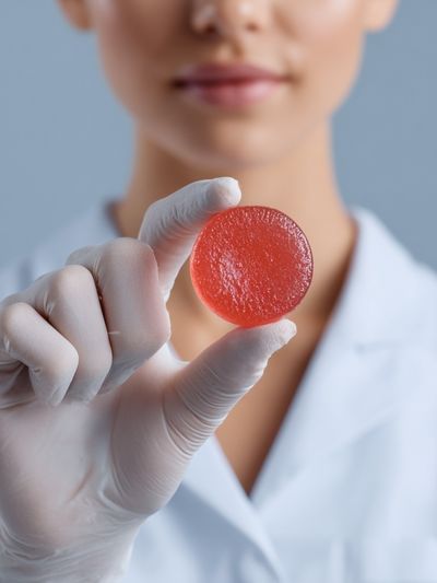 Lab Technician Holding Red Candy Poster. poster