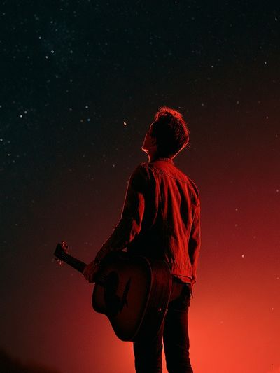 Guitarist Under Red Sky Photography Poster.