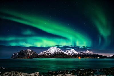 Northern Lights Over Snowy Mountains — Photography Print. poster