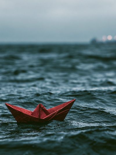 Red Paper Boat at Sea Photography Poster.