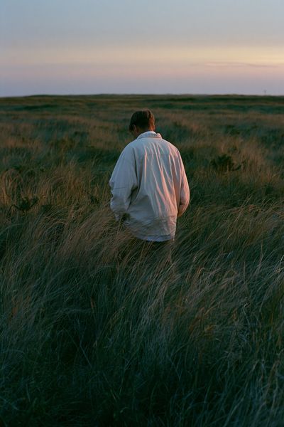 Solitary Figure in Grassland Poster.