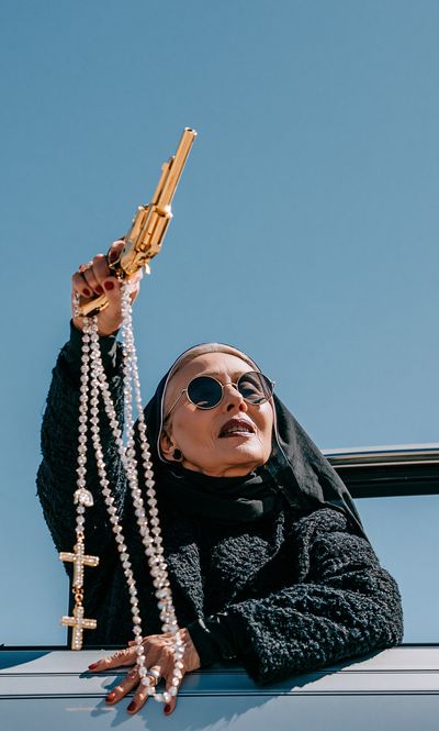 Nun with Gold Gun Photography Poster.