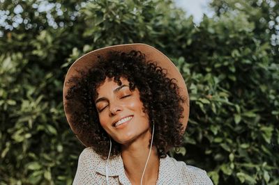 Beautiful woman listening music botanical.