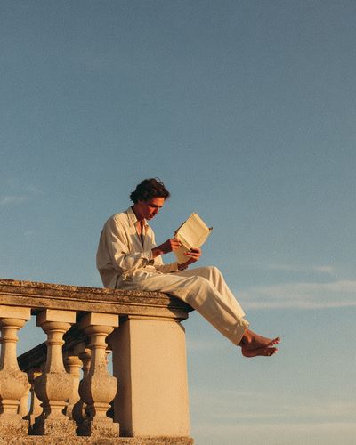 Sunlit Reader on Terrace Photography Poster. poster print