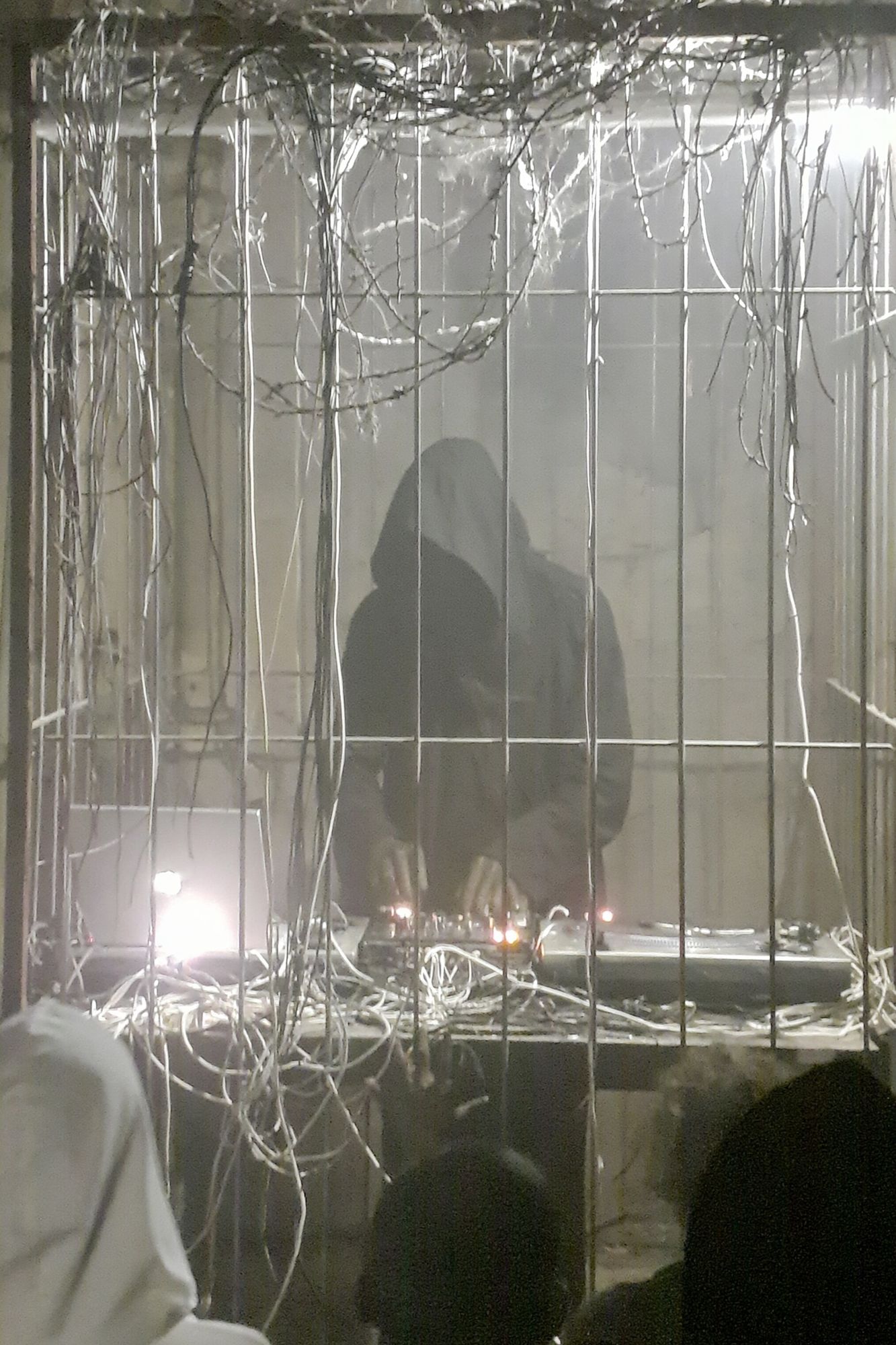Hooded Figure in Wire Cage Poster. poster detail