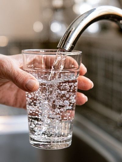 Filling Glass at Sink Photography Poster. poster