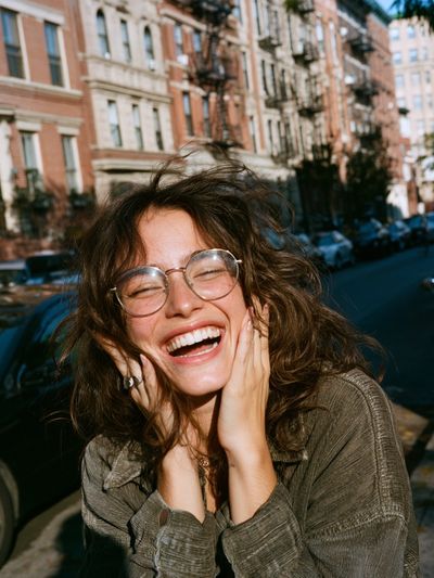 Smiling Woman in City Street Poster.