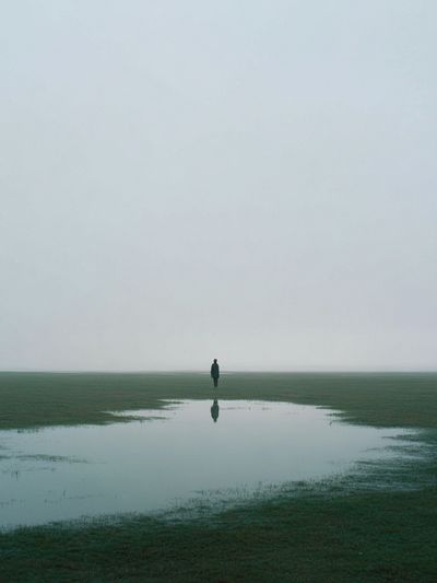 Lone Figure in Misty Field Poster.
