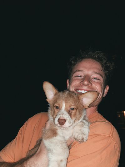 Smiling Man with Puppy Portrait Poster.