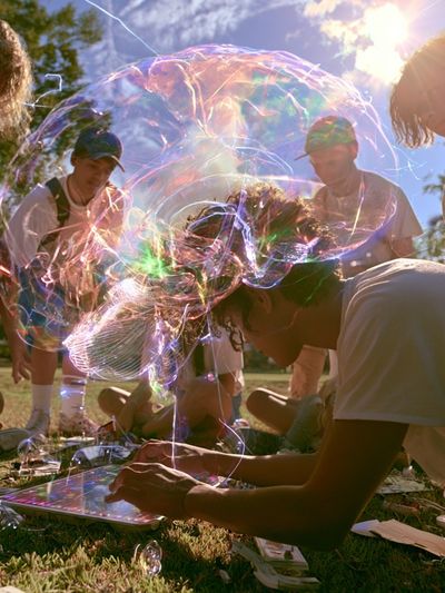 Sunlit Bubble Gathering Photography Poster.