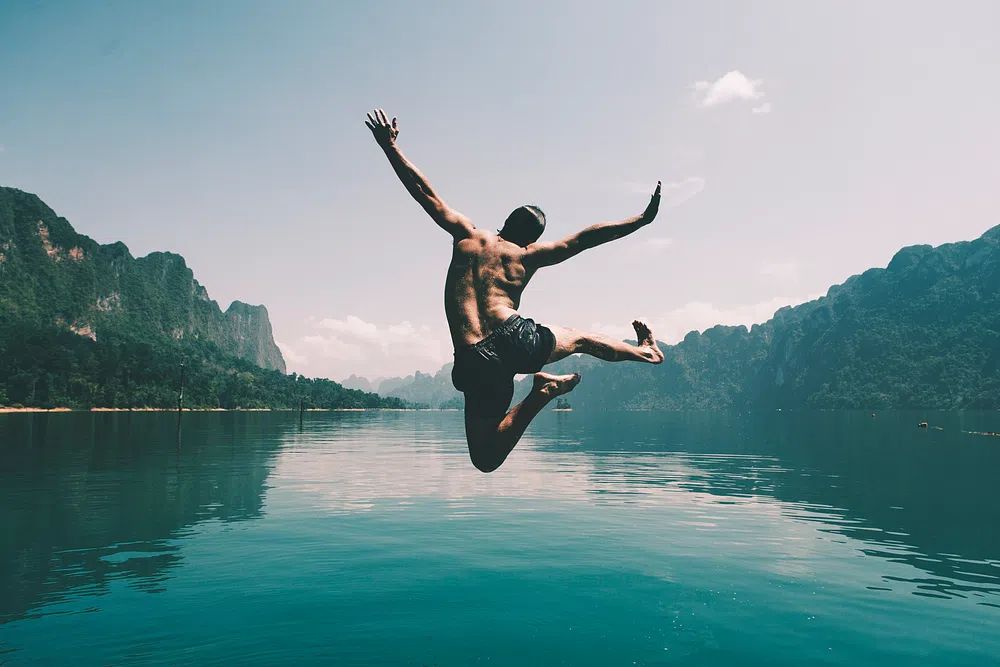 Man jumping joy lake. poster — photography art