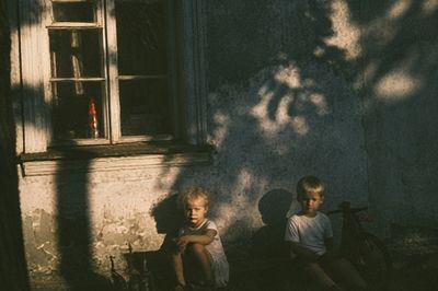Children in Sunlit Courtyard Photography Poster. poster