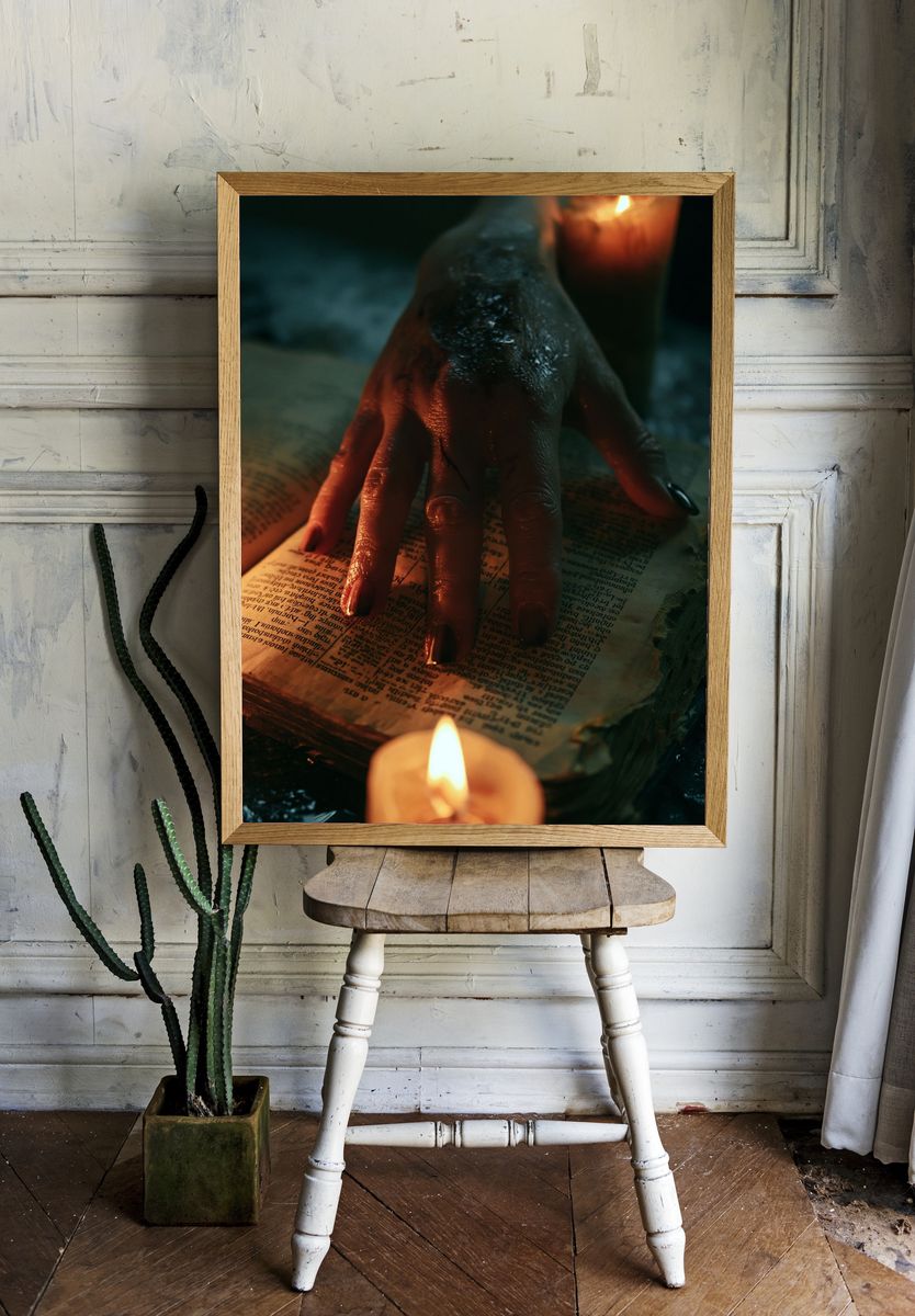 Candlelit Hand on Open Book Poster. room preview