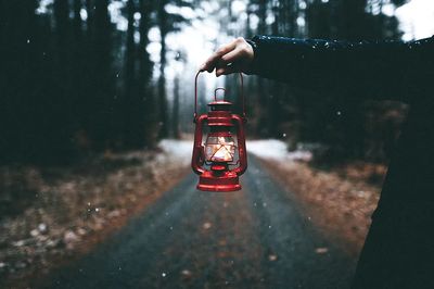 Hand holding lantern adirondack mountains.