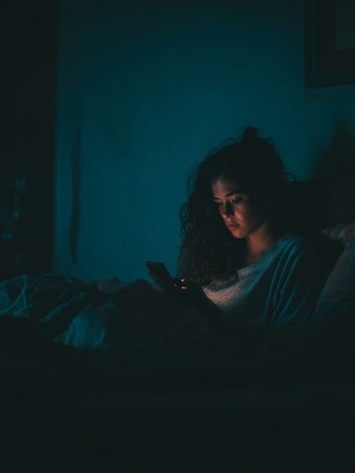 Woman Using Phone at Night — Photography Print. poster
