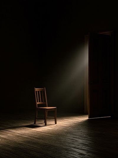 Lonely Chair in Dark Room Poster.