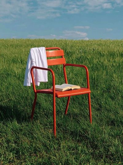Red Chair in Meadow Photography Poster.