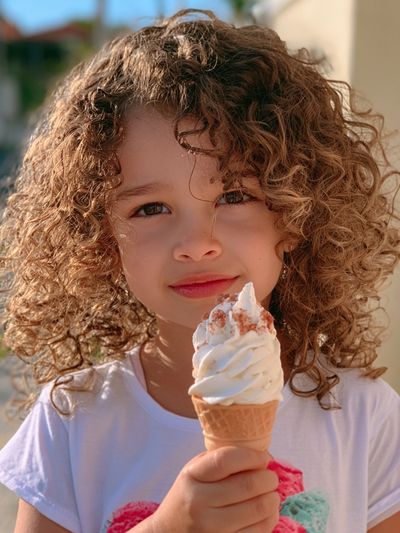 Curly Child with Ice Cream Photography Poster. poster