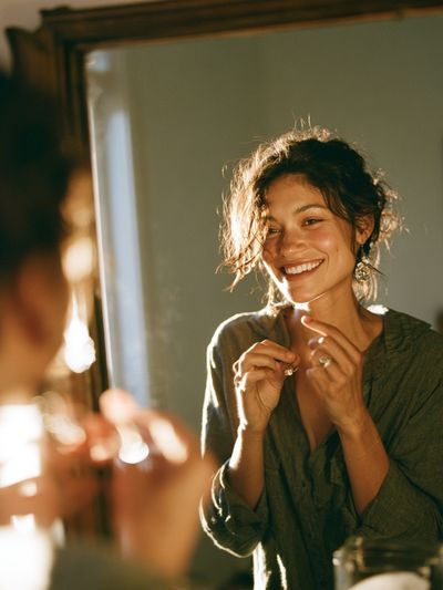 Smiling Woman in Mirror Photography Poster.