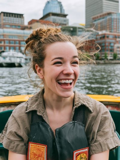 Smiling Woman on Harbor Boat Poster.