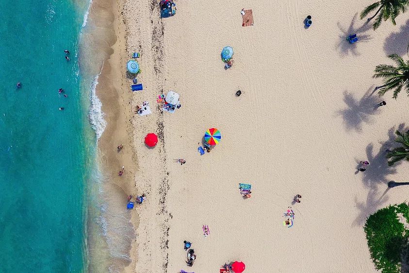 aerial shot tourists sunbathing sand. poster detail