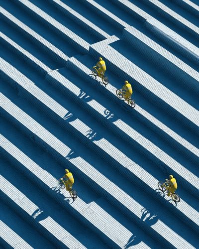 Cyclists in Blue Steps Photography Poster.