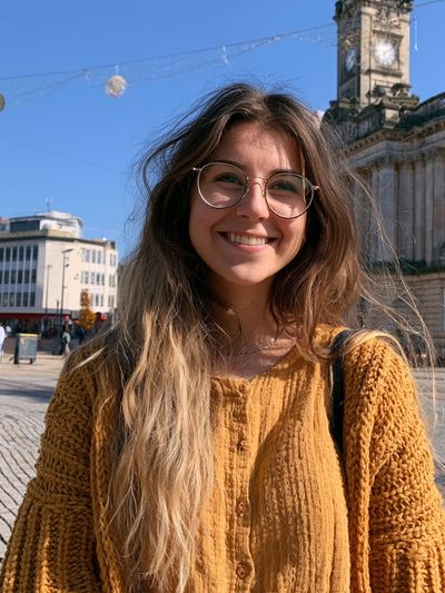 Smiling Woman in City Square Poster.