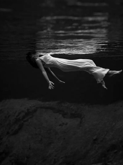 Underwater view woman, wearing long.