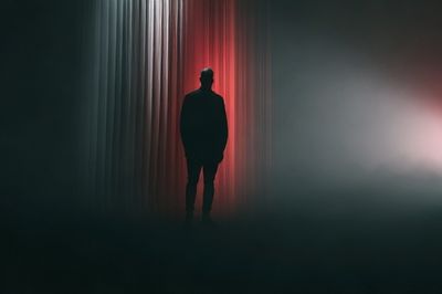 Silhouetted Figure in Red Light Print.