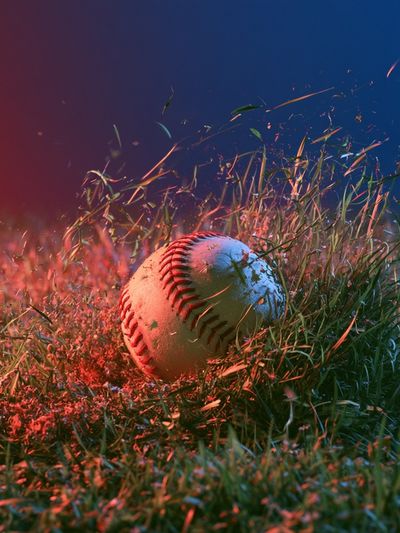 Glowing Baseball in Grass Photography Poster.