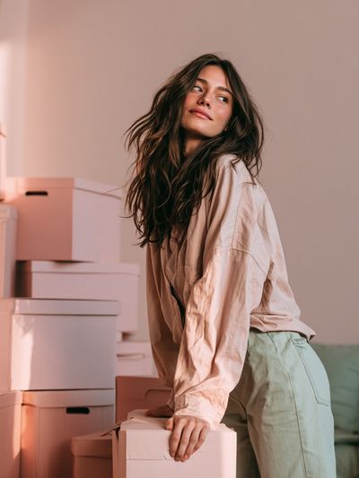 Woman Among Boxes Photography Poster.