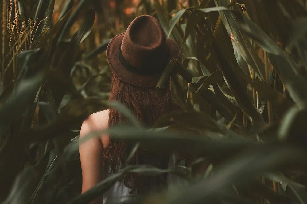 girl wearing brown hat walking. poster detail