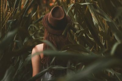 girl wearing brown hat walking.