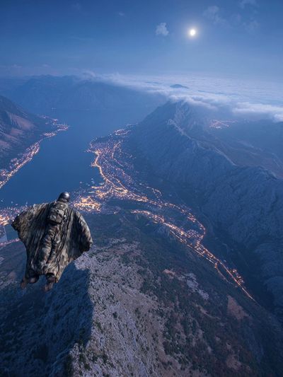 Wingsuit Over Moonlit Mountains Poster. poster