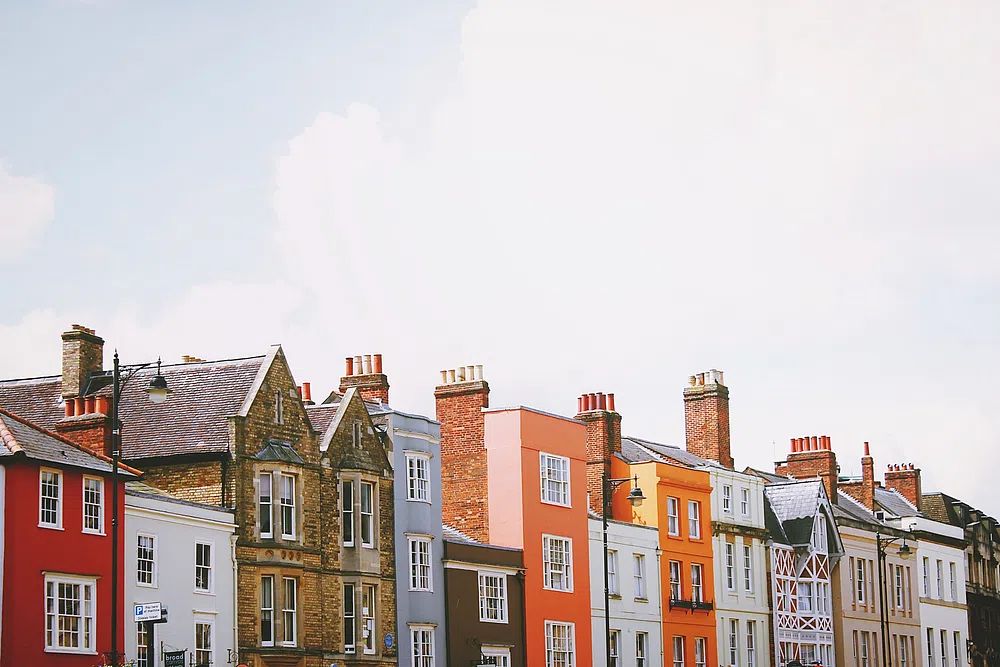 Assorted-color concrete row houses white. poster — architecture art