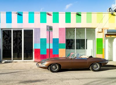 Classic Car Against Colorful Wall Poster. poster print