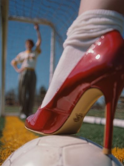 Red High Heel on Soccer Ball — Playful Print. poster print