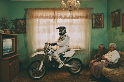 Motorcyclist in Vintage Living Room Poster. poster