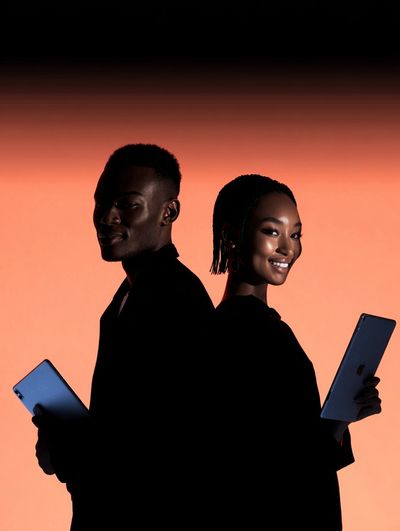 Silhouetted Couple with Tablets — Photography Print. poster print