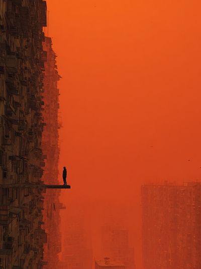 Solitary Figure in Orange Cityscape Poster. poster
